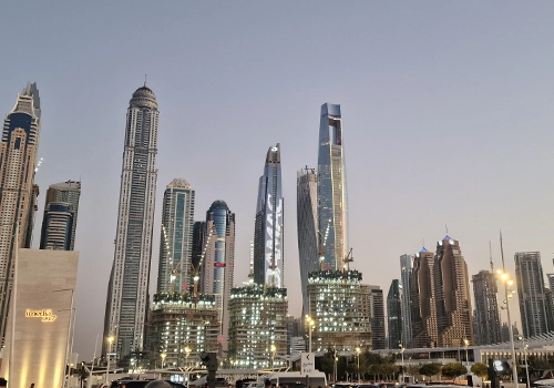 Dubai Marina skyline at sunset with illuminated skyscrapers