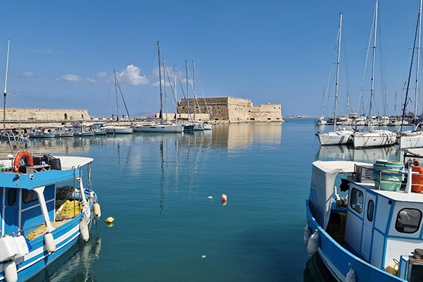 Heraklion old port fishing boats with Koules Fortress in Crete Greece