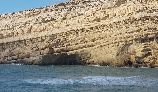 matala beach crete sea cliffs and sandy beach