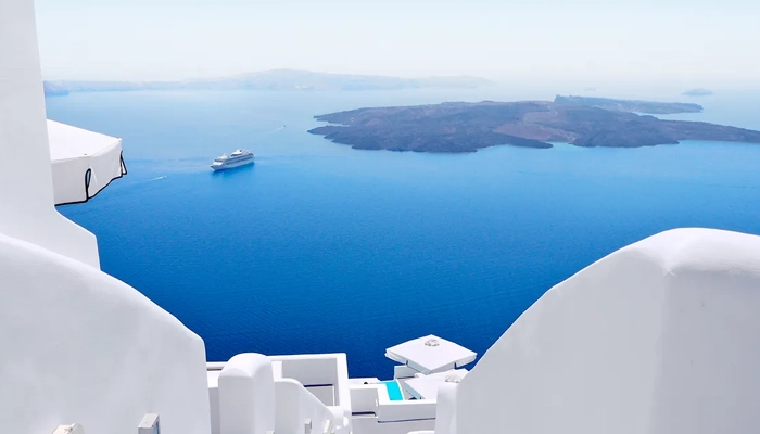 Santorini caldera view with white houses and blue sea on a day trip from Crete