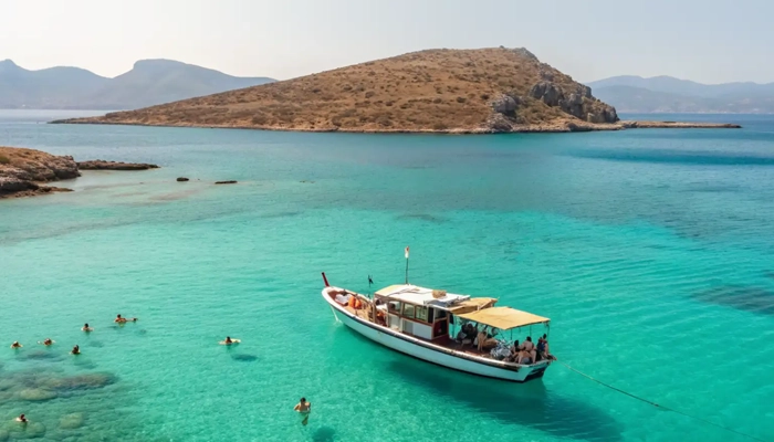 Boat swimming stop in turquoise waters during Spinalonga BBQ tour in Crete with Car and Travel