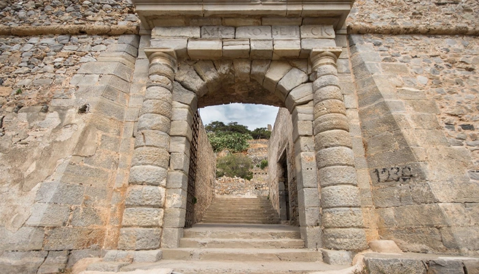 Stone entrance gate of Spinalonga in Crete during BBQ tour