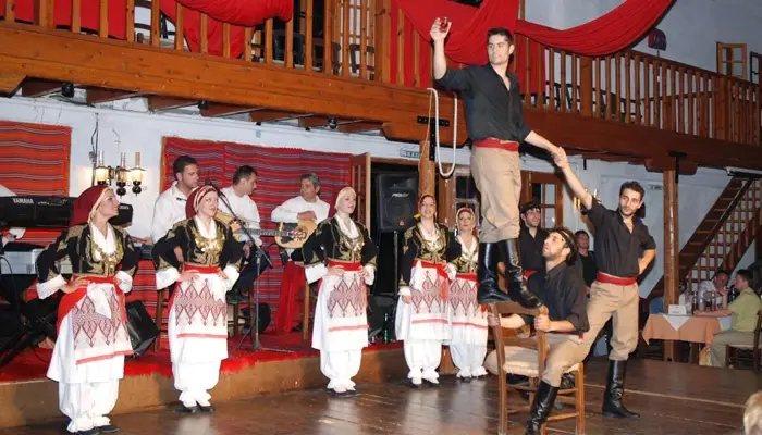 Cretan Night dancers performing acrobatic chair act during traditional dance show in Karouzanos Crete