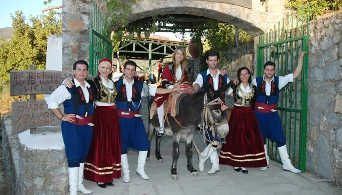 Entrance of Cretan Night in Karouzanos village with traditional costumes and donkey welcome in Crete