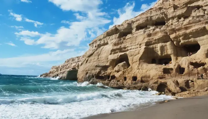 Matala beach waves and rocks in Crete during Matala Odigitria day trip with Car and Travel