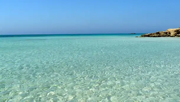 Elafonisi lagoon crystal clear turquoise water under blue sky Crete